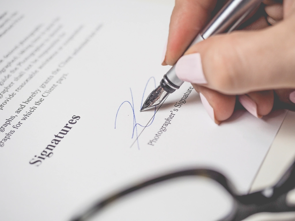 A document being signed at a desk