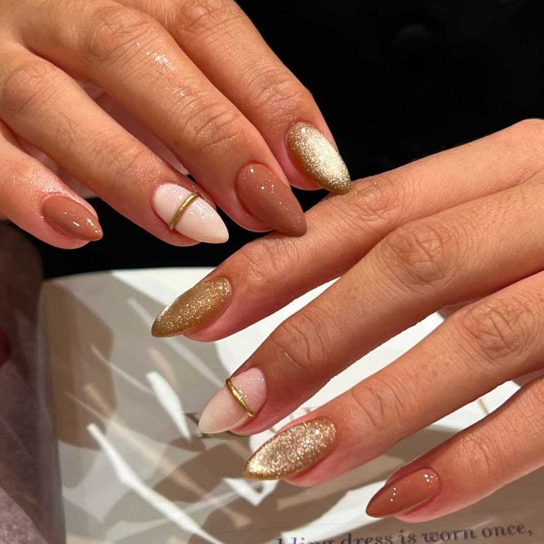 Gel extensions with a gold accent nail by Couture Studio