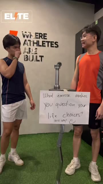Members at ELITE Fitness in front of the Where Athletes Are Built wall