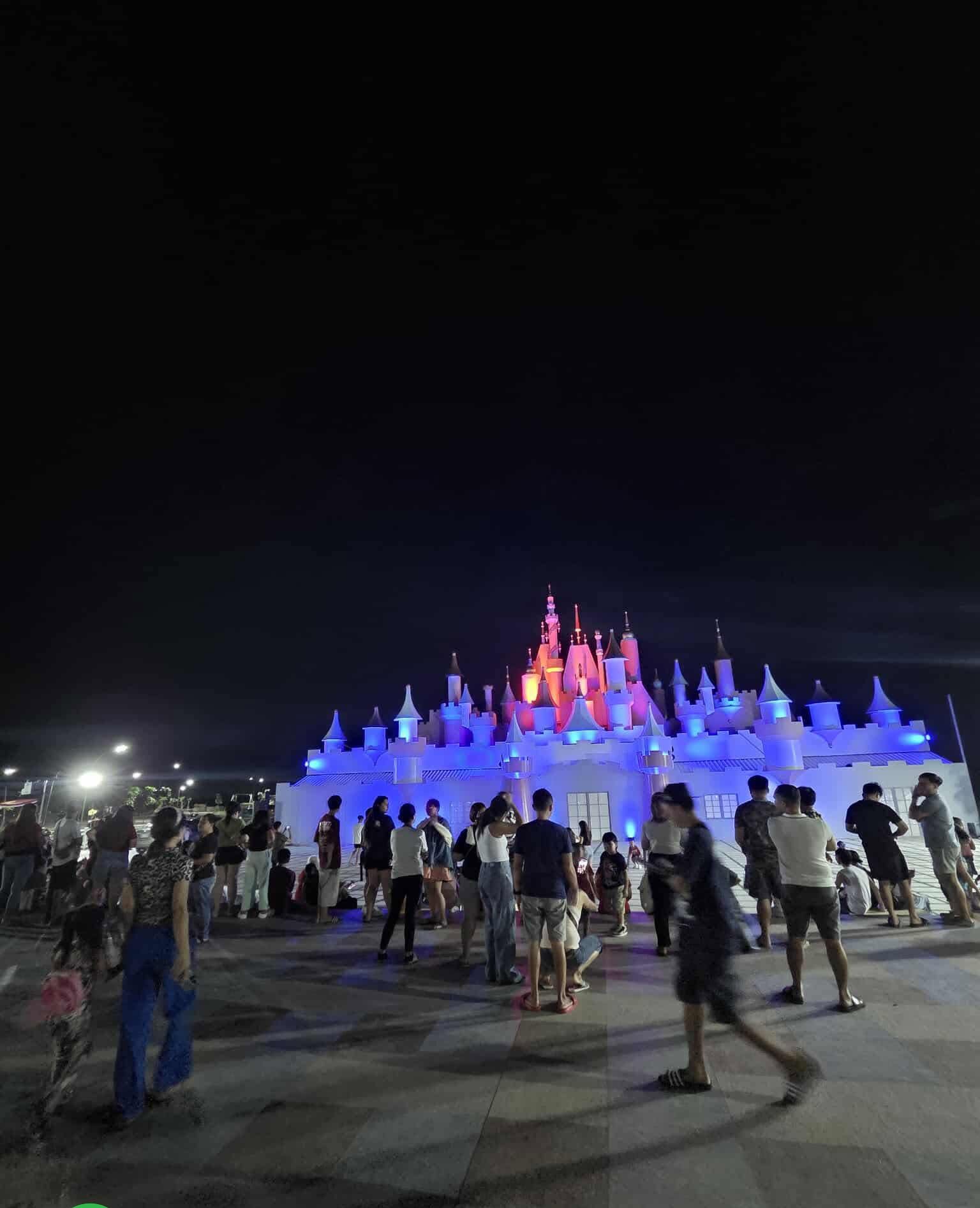 The castle glowing blue at night